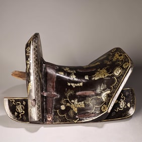 A wooden lacquerware saddle