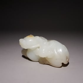 A Qing Dynasty Hetian jade boy playing with cows