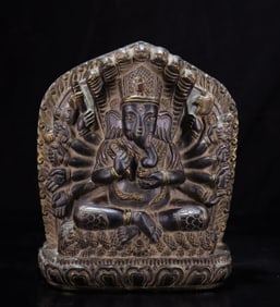 A black stone carved elephant trunk god of wealth