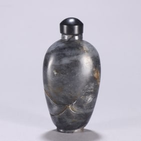 A blue and white seed bottle