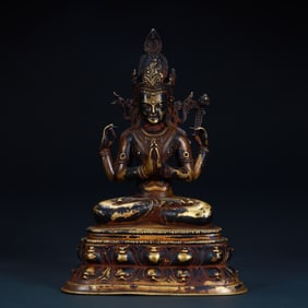 Statue of Guanyin with four arms in clear copper and gold mud