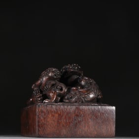 A Qing Dynasty agarwood child and mother beast button seal