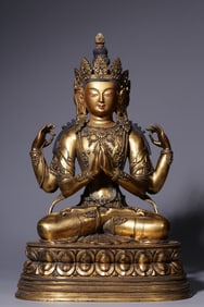 A seated statue of Guanyin with four arms in copper gilt in the Qing Dynasty