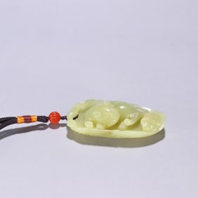 A Qing Dynasty Hetian topaz auspicious beast pendant