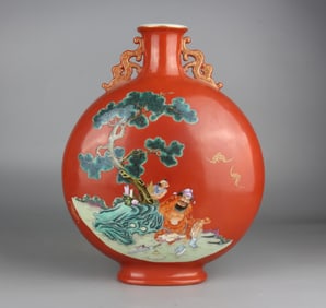 A Qing Qianlong coral red pastel figure holding the moon vase with both ears