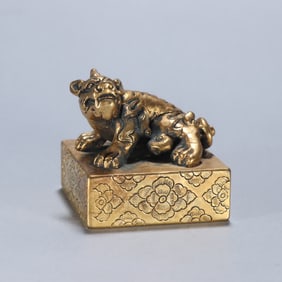 A copper gilt beast button seal
