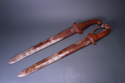 A pair of jade swords with ancient jade inscriptions