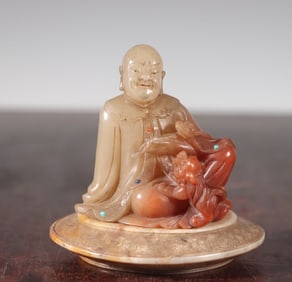 A Qing Dynasty Shoushan stone inlaid with a statue of a treasured Arhat