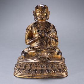 A Qing Dynasty bronze clay gold guru statue