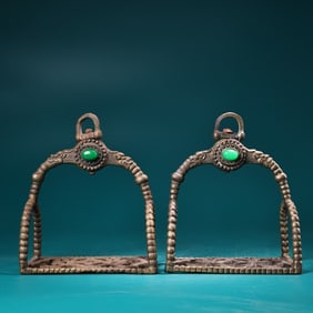 A pair of copper-inlaid gemstone stirrups