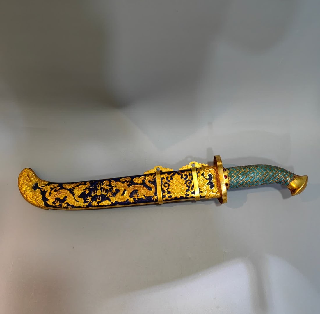 A Qing Dynasty copper-gilt cloisonné sword: Qing Dynasty copper gilt cloisonné sword SIZE: Weight 1236g Length 56cm Width 13cm Thickness 8cm (The Dimensions Of All Batches Are Manually Measured.If You Need More Detailed Information, Please Con