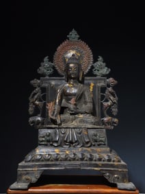 A bronze gold split backlit statue of the Medicine Buddha