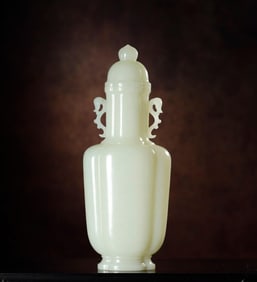 A Qing Dynasty white jade ruyi ear cap bottle