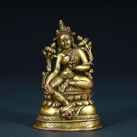 A bronze gilt green Tara statue