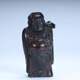 A statue of a monk in a carved cloth bag made of rosewood in the Qing Dynasty