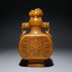 A Qing Dynasty Tian yellow carved dragon pattern thin animal ear bottle