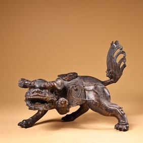 A high-relief engraved lacquered gold lion