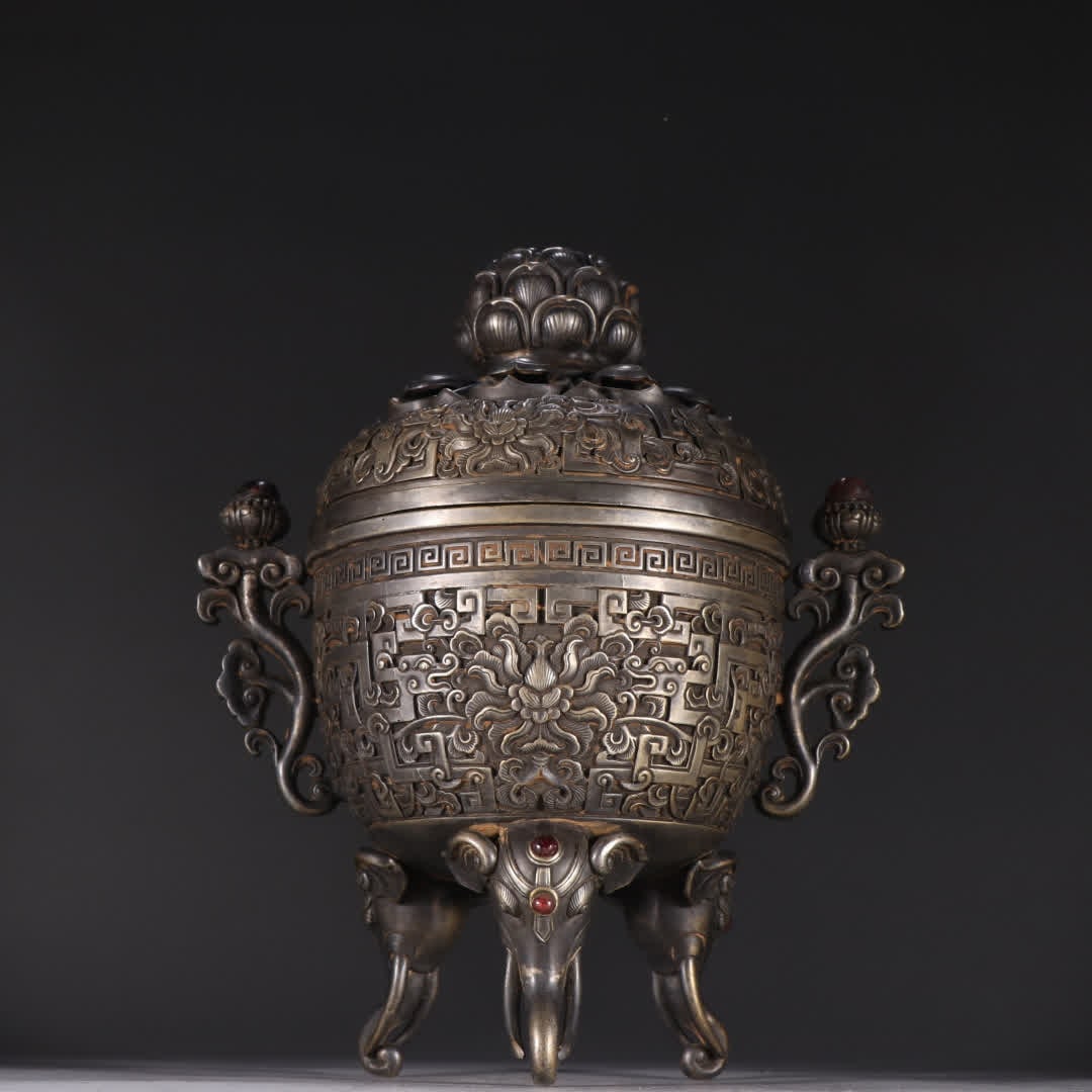 A Qing Dynasty copper-gilt silver elephant head three-legged aromatherapy stove (1 of 9)