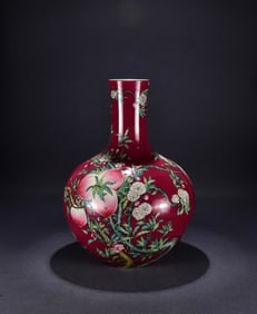 A Qing Qianlong red ground pastel nine peaches and five blessings Tianqiu vase