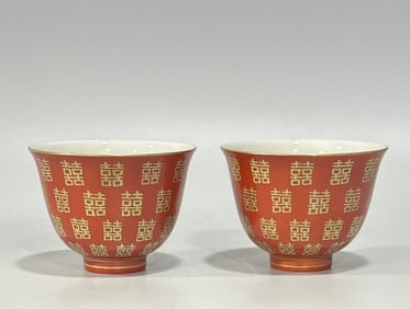 A pair of Qing Tongzhi pastel coral red gold-painted double happiness pattern cups