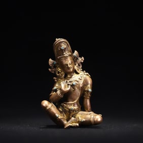 A Qing Dynasty copper gilt inlaid turquoise Guanyin statue