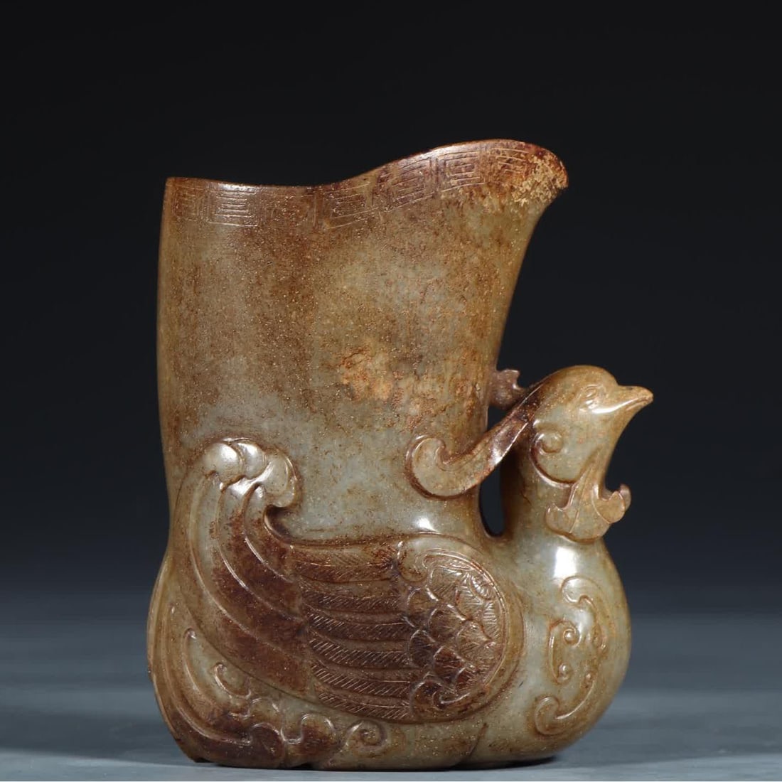 A Qing Dynasty Hetian jade seed material phoenix head cup: Qing Dynasty Hetian jade seed material phoenix head cup SIZE: L:8.4cm W:5.6cm H:10.6cm W:423g (The Dimensions Of All Batches Are Manually Measured.If You Need More Detailed Information, Please Contact