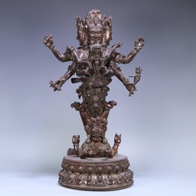 A Qing Dynasty rosewood three-sided and six-armed joy Buddha Vajra stake