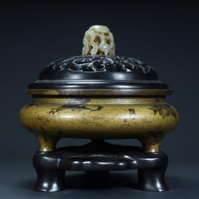A Qing Dynasty copper sprinkled gold three-legged aromatherapy stove