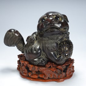 A Qing Dynasty rosewood carved lion ornament