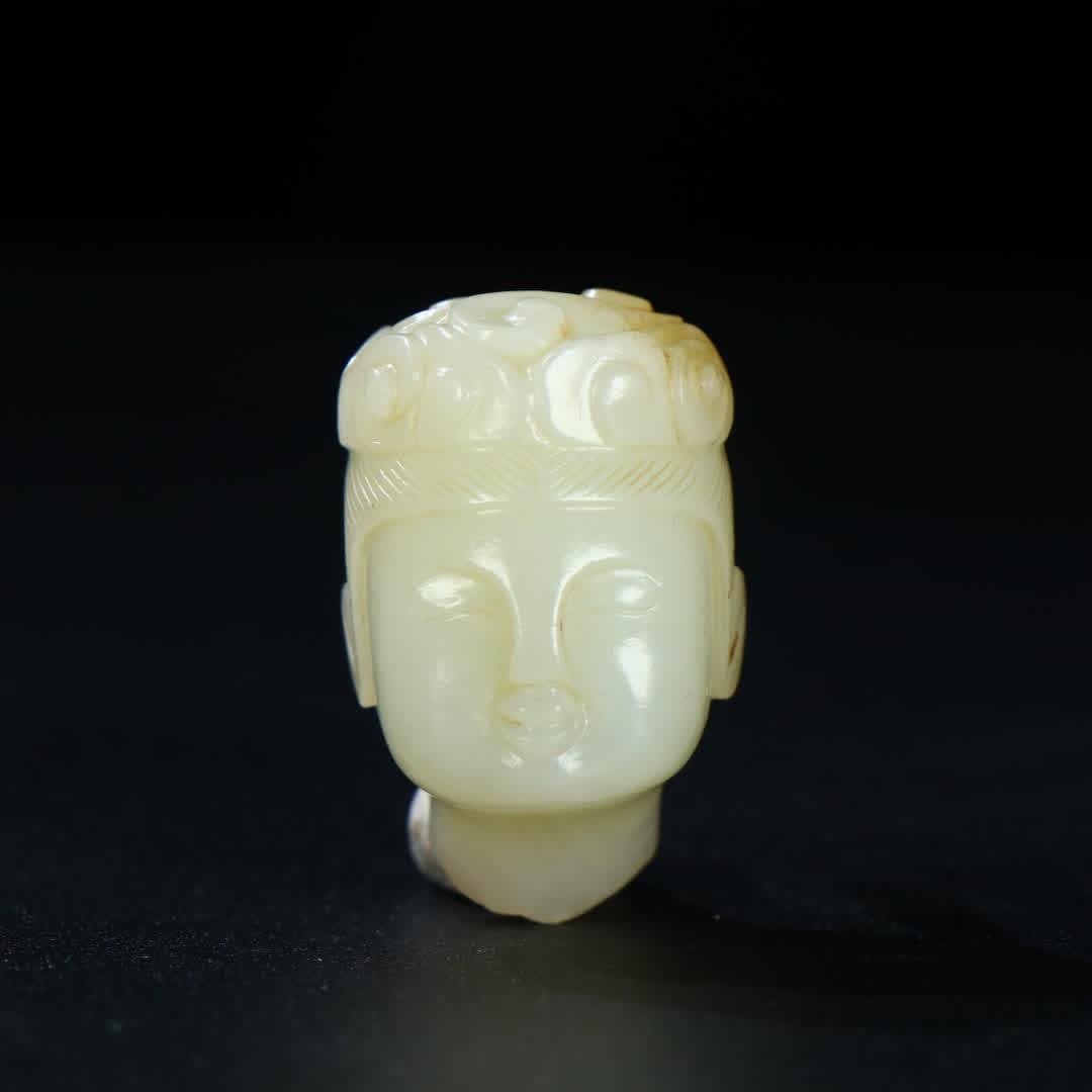 A head ornament of a medieval jade flying boy (1 of 9)