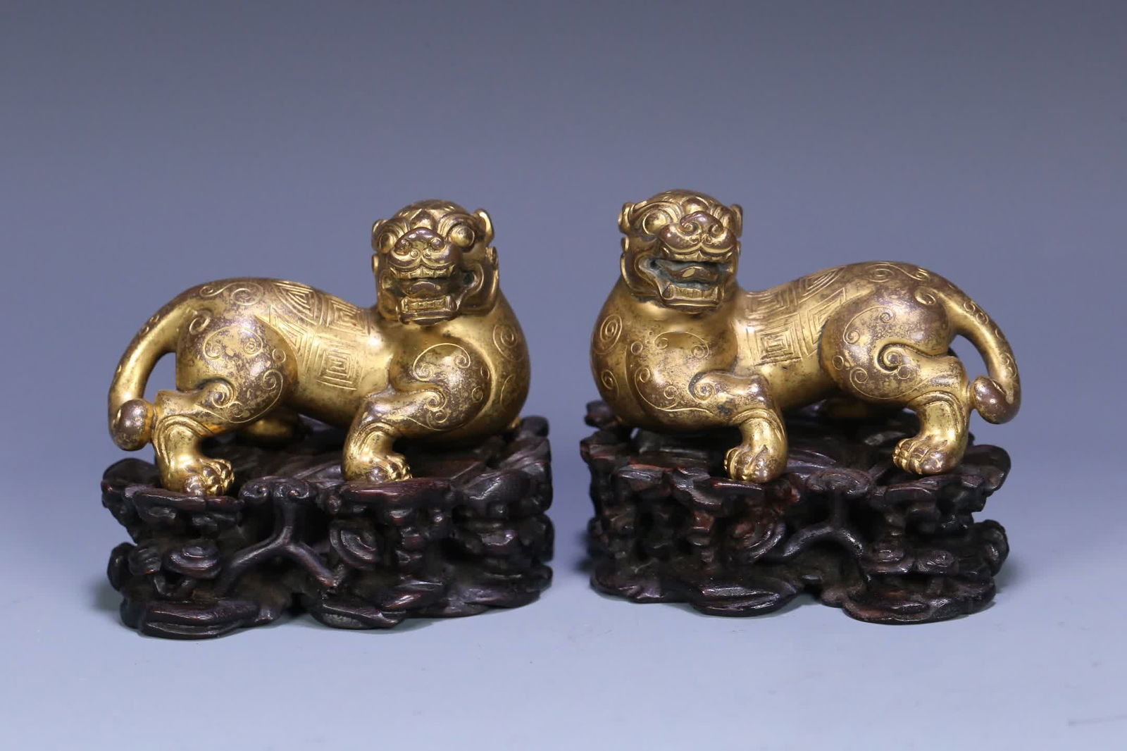 A pair of Qing Dynasty rosewood support copper gilt auspicious beast ornaments (1 of 9)