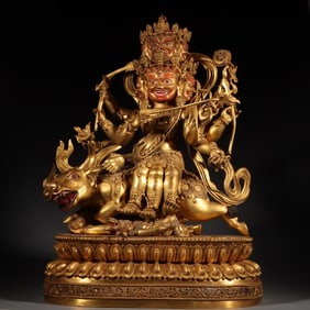 A Tibetan bronze gilt red statue of the God of Wealth