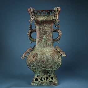 A bronze square serpentine vase