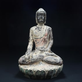A seated statue of a painted stone Buddha in the Tang Dynasty