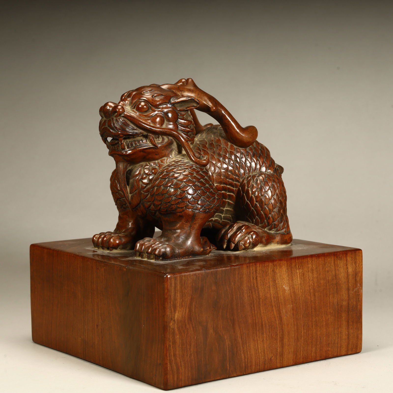 A Qing Dynasty rosewood auspicious beast button seal (1 of 8)