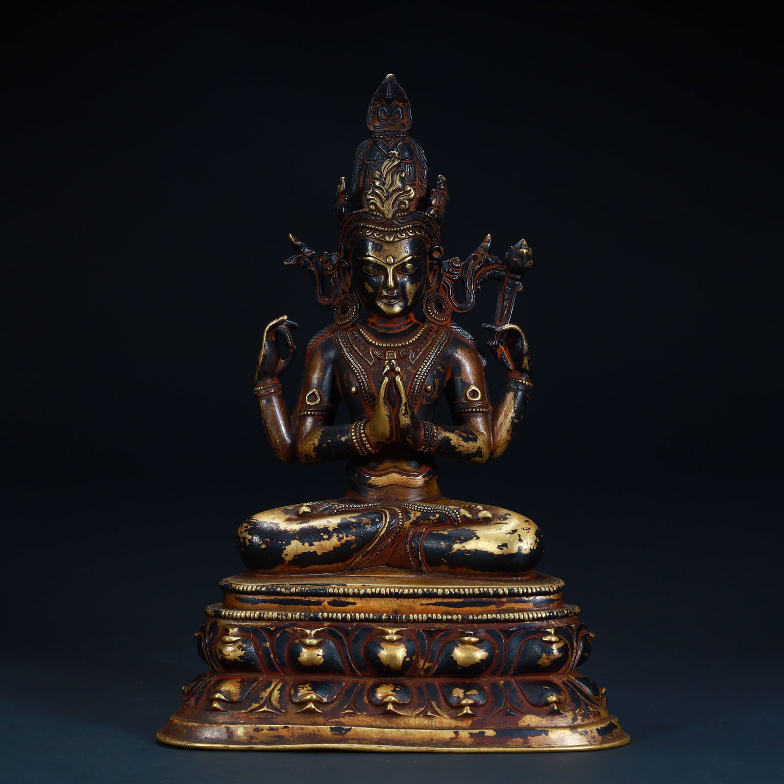 A statue of Guanyin with four arms in copper mud and gold (1 of 12)