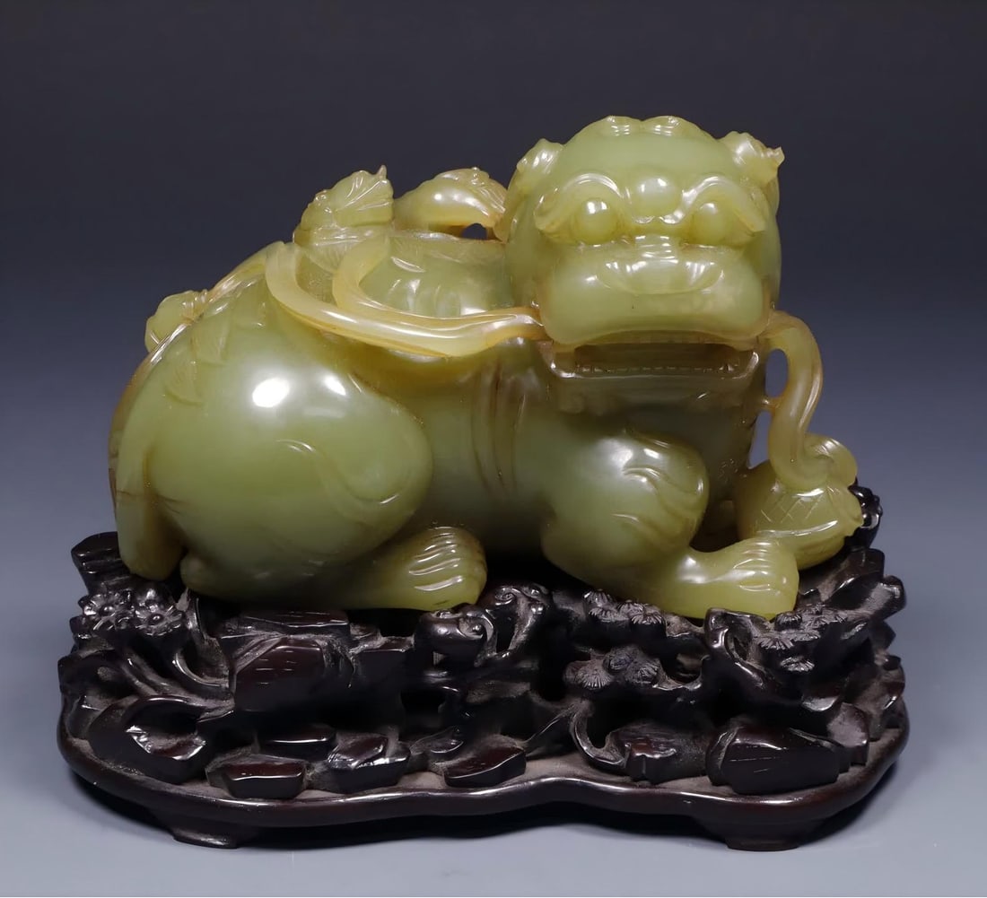 A Qing Dynasty Hetian topaz auspicious beast ornament: Qing Dynasty Hetian topaz auspicious beast ornament SIZE: Total H: 11.0cm Seat L: 14.0cm W: 8.8cm Total W: 900.5g Net L: 12.0cm H: 7.8cm W: 6.6cm W: 747.4g (The Dimensions Of All Batches Are Manually