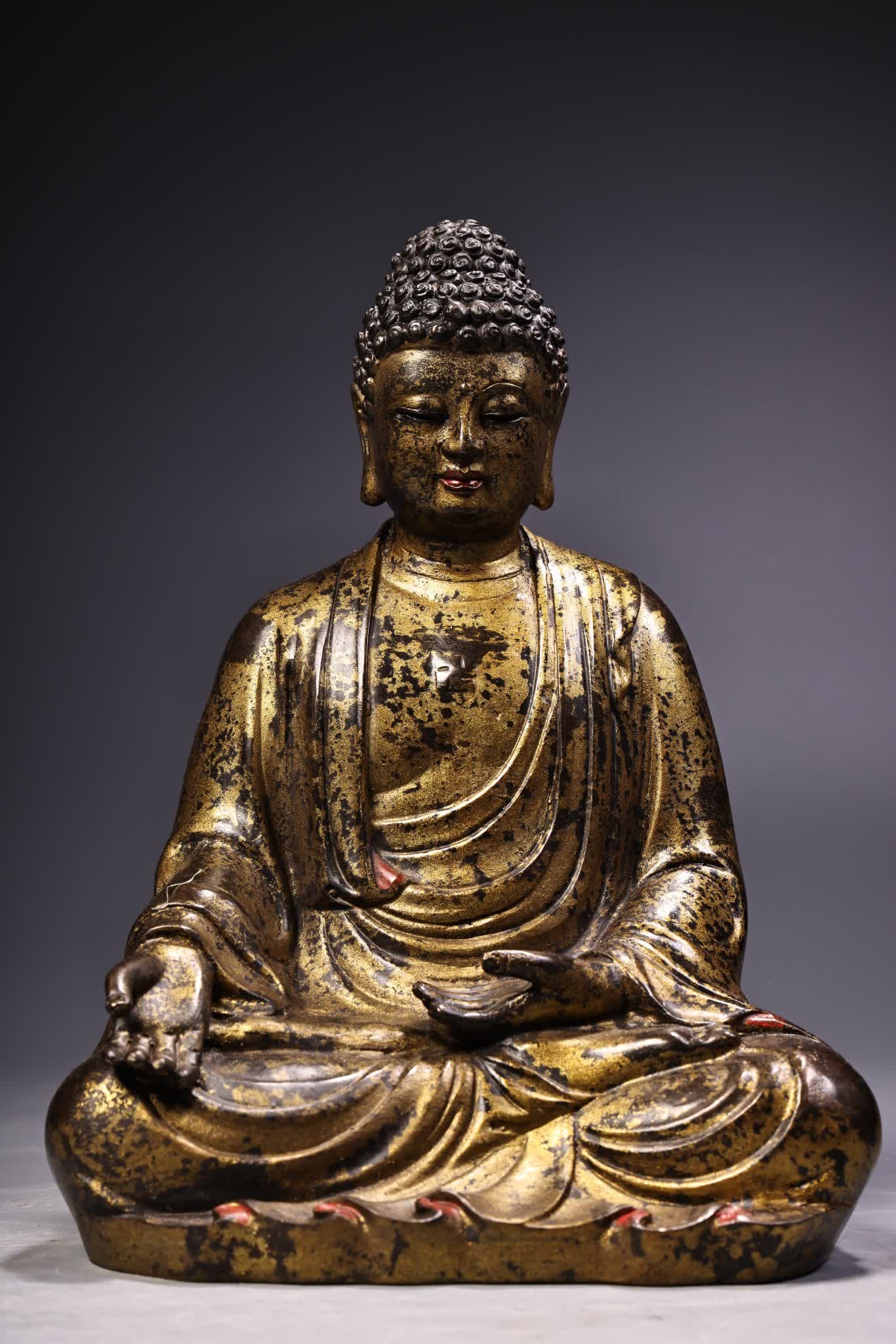 A statue of Buddha Buddha in gold clay carving (1 of 12)