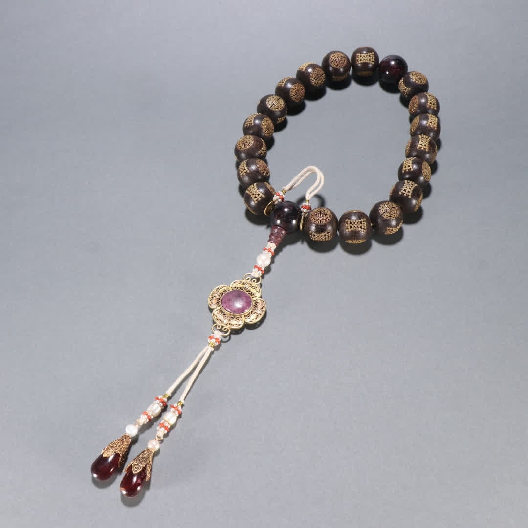 A piece of Qing Dynasty agarwood inlaid silver gilt longevity pattern eighteen sons hand (1 of 9)