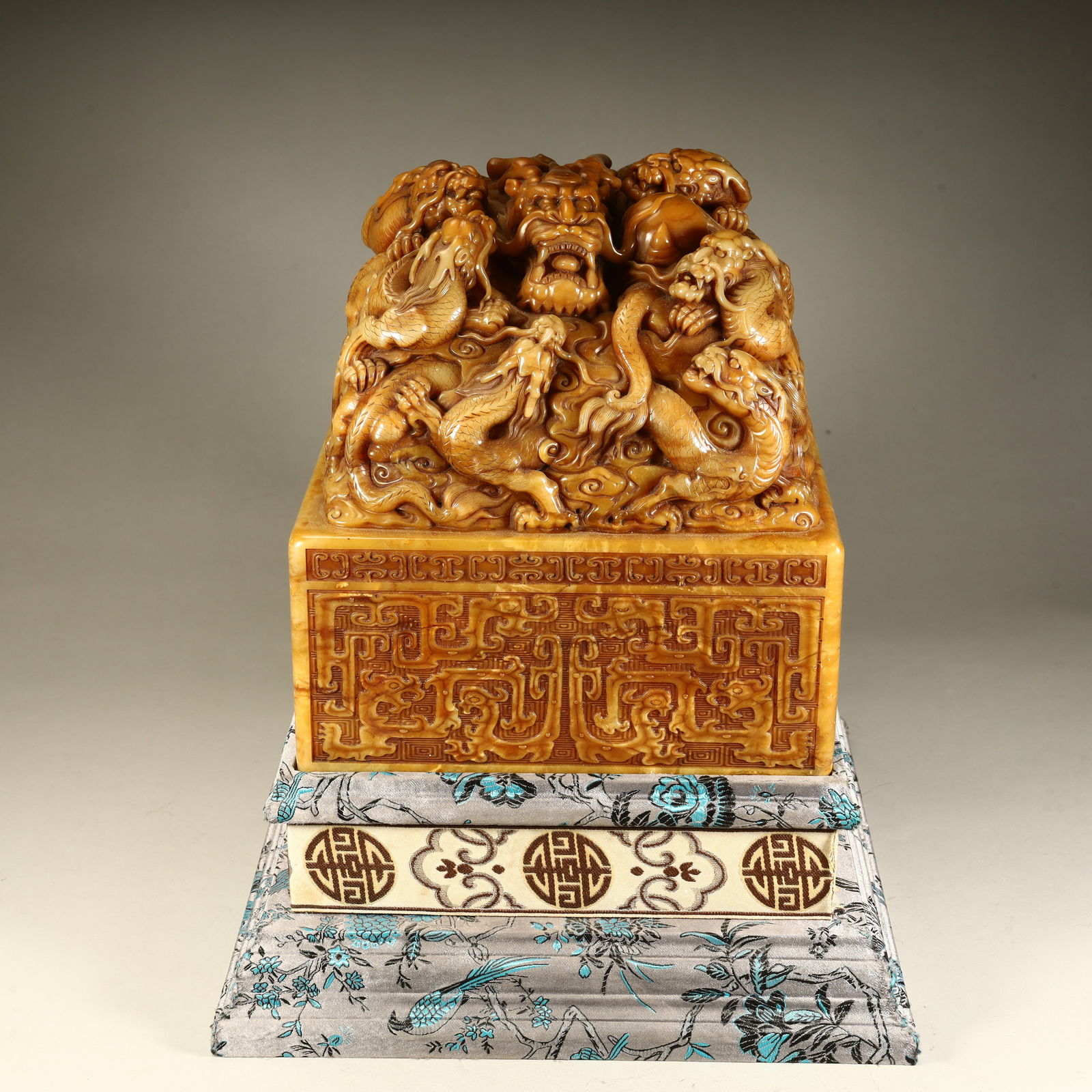 A Qing Dynasty Shoushan stone nine dragon button seal (1 of 9)