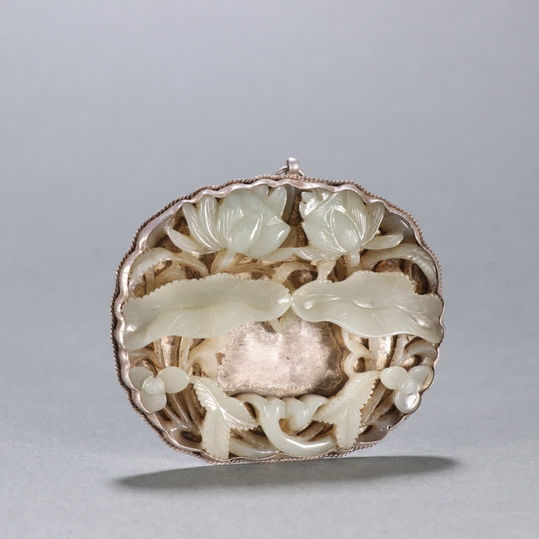 A Qing Dynasty silver-inlaid Hetian jade lotus pendant (1 of 9)