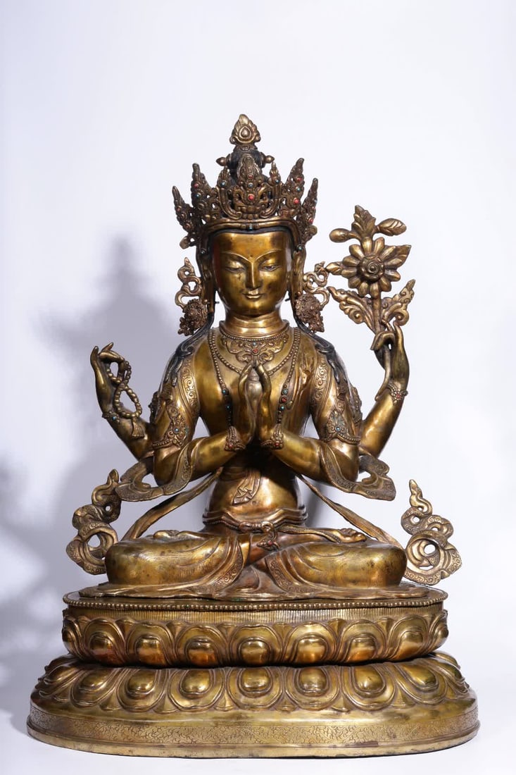 A seated statue of Guanyin with four arms in copper gilt in the Qing Dynasty (1 of 14)