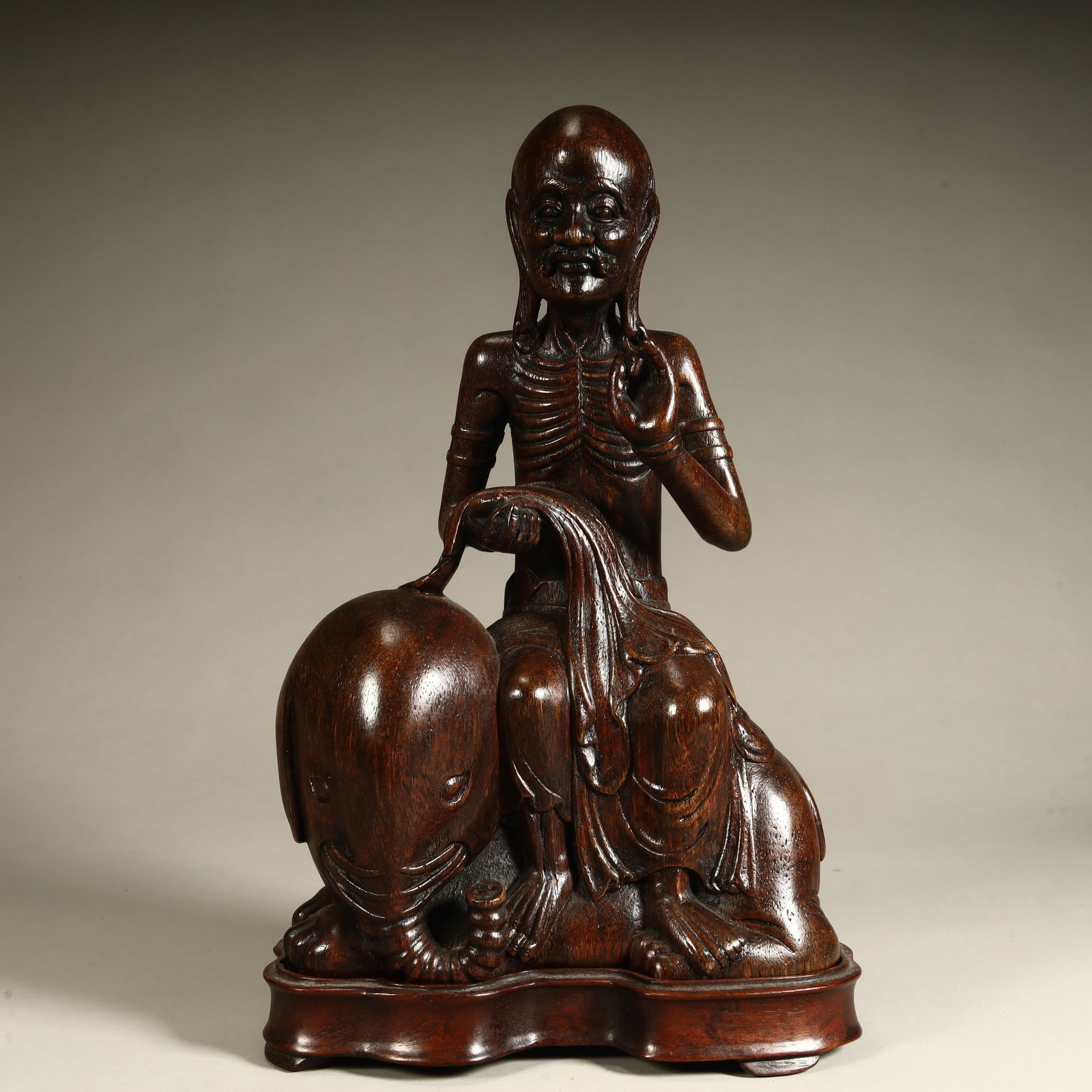 A Qing Dynasty agarwood carved statue of an elephant riding an Arhat: Qing Dynasty agarwood carving riding elephant Arhat statue size and quantity SIZE: H:24cm L:15cm W:8cm W:392.3g (The Dimensions Of All Batches Are Manually Measured.If You Need More Detailed Informati