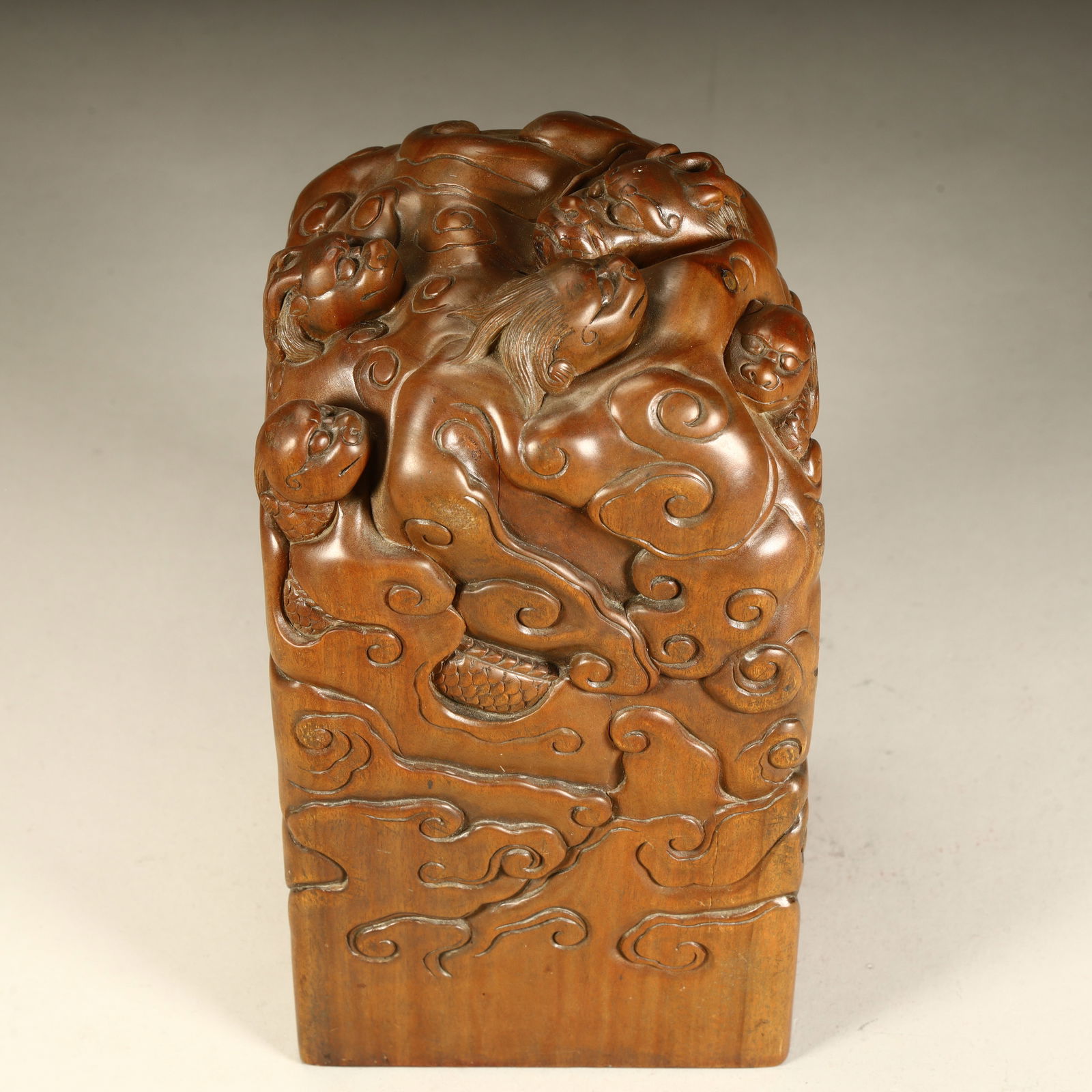 A Qing Dynasty boxwood carved cloud pattern auspicious beast button seal (1 of 10)