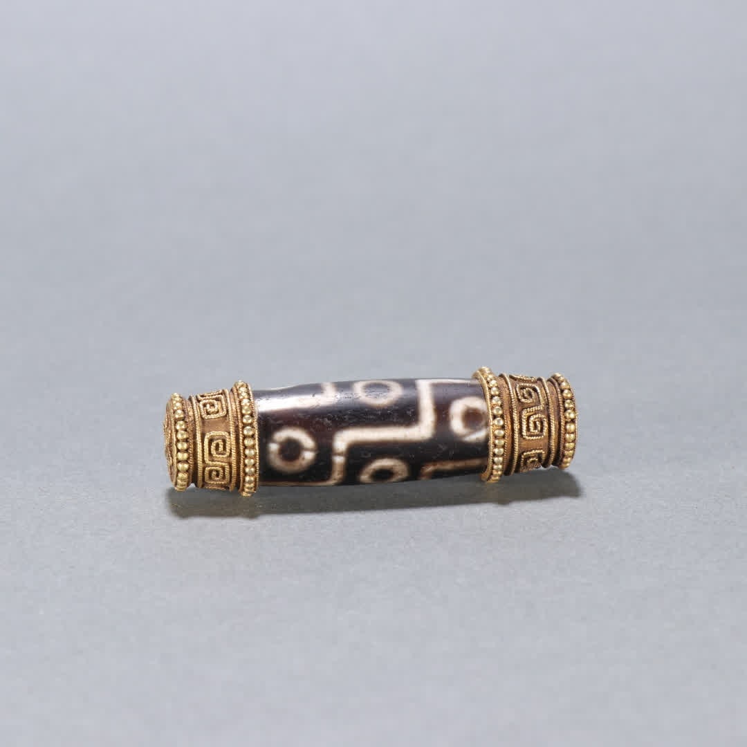 A gold-clad nine-eyed dzi: Gold-clad nine-eyed Dzi SIZE: L:5.5cm W:1.6cm W:23.7g