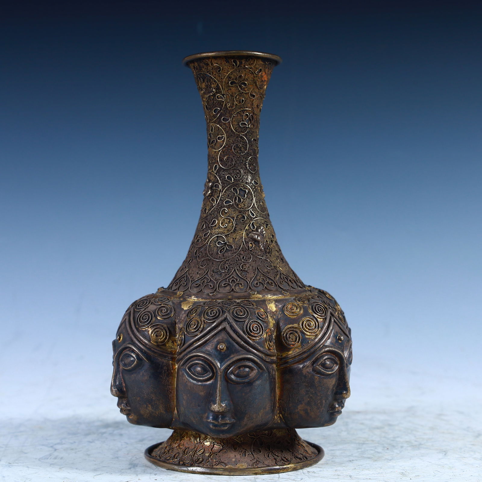 A Tang Dynasty copper multi-faceted head pattern bottle: Tang Dynasty copper multi-faceted head pattern bottle SIZE: H:19cm W:13cm W:0.5kg