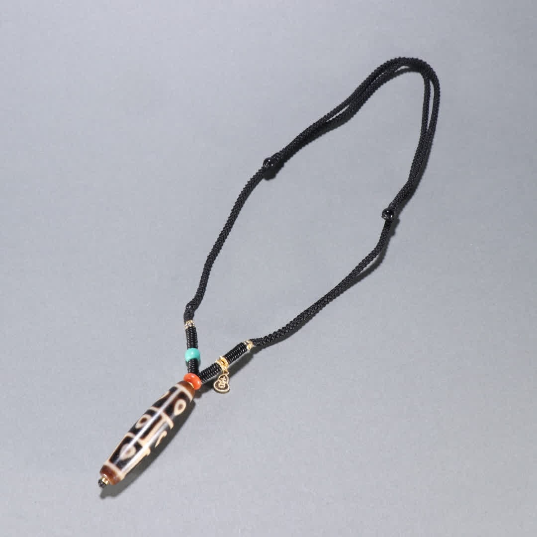 A Qing Dynasty nine-eyed Dzi pendant: Qing Dynasty nine-eyed Dzi pendant SIZE: L:5.4cm W:1.3cm W:18.3g