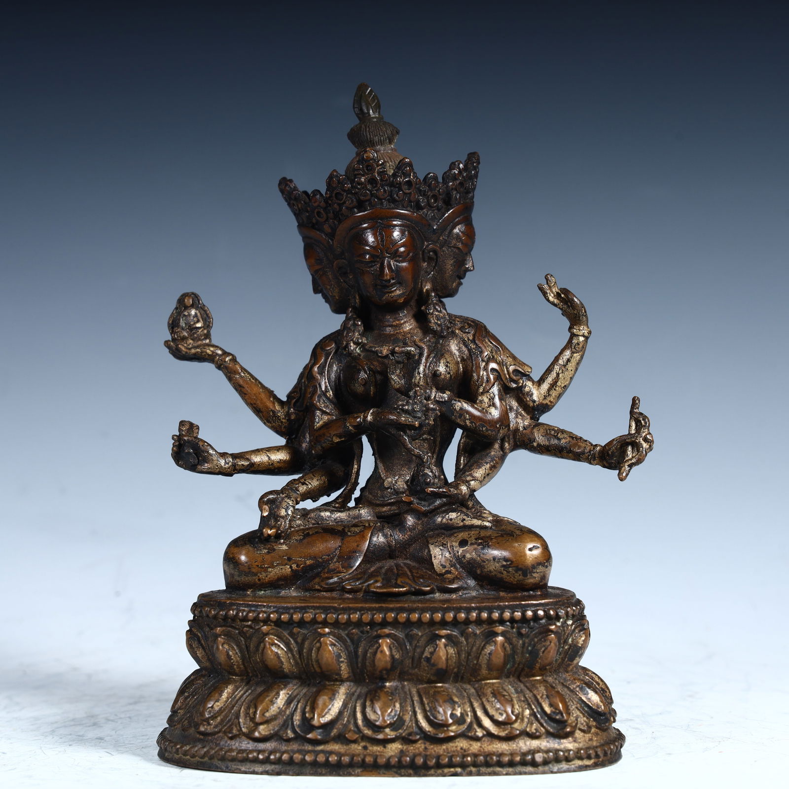A Qing Dynasty bronze gilt three-sided and eight-armed Guanyin statue (1 of 12)