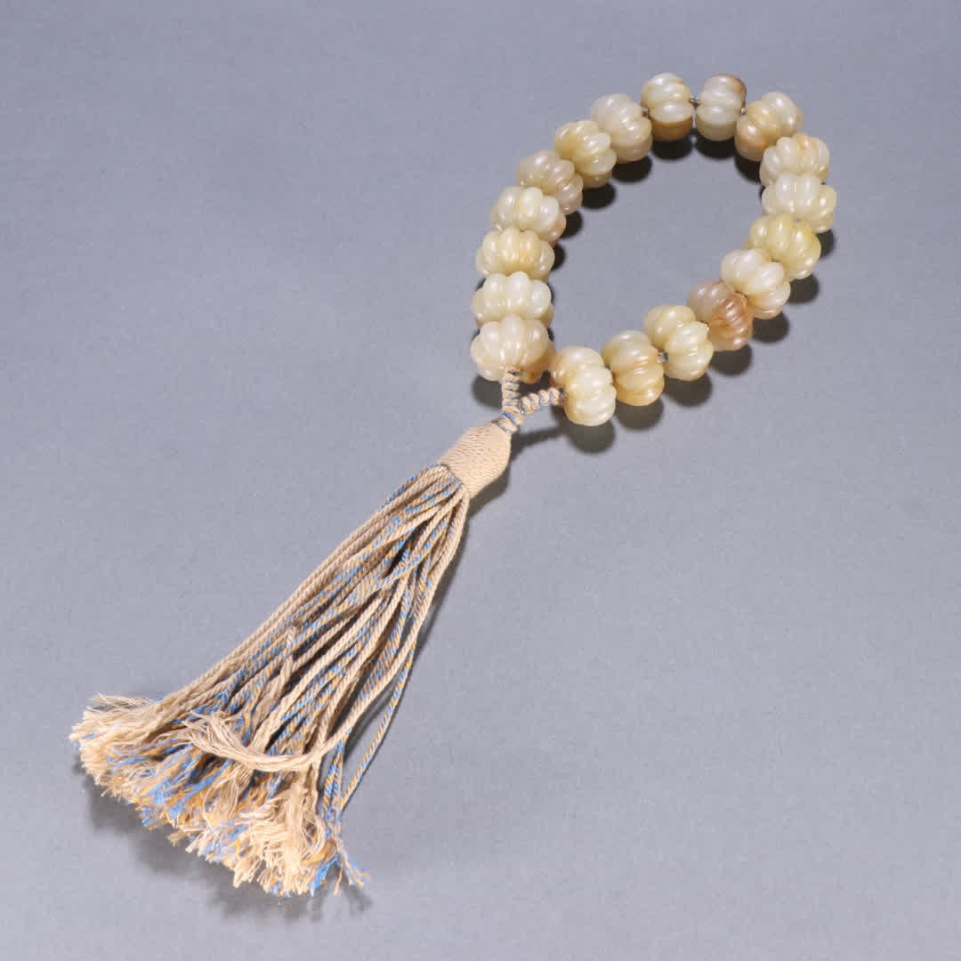 A piece of Qing Dynasty Hetian jade melon ridge eighteen sons held (1 of 9)