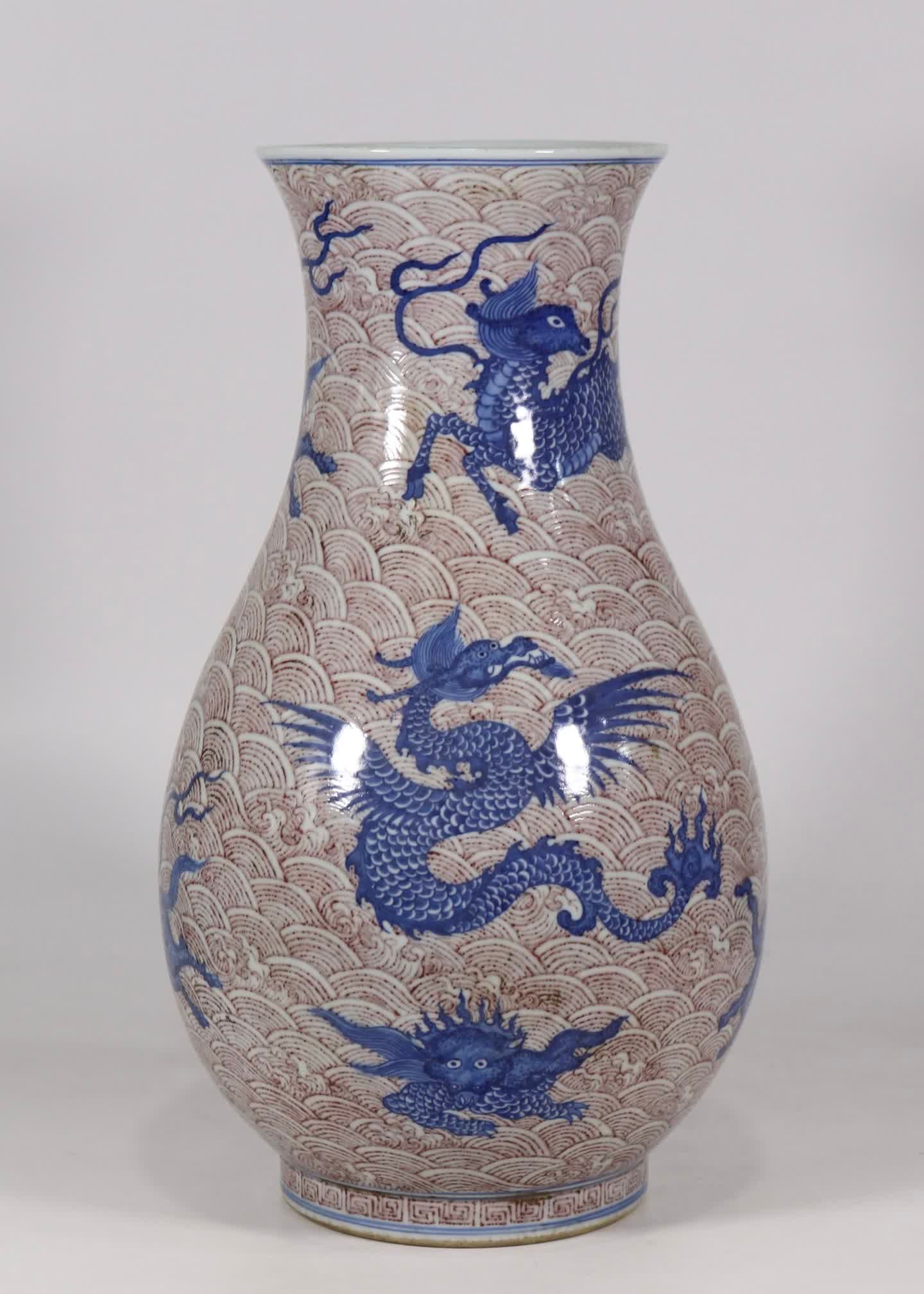 A blue and white glazed red sea water beast pattern fish basket bottle made in the Qianlong period: Qing Qianlong year blue and white glazed red sea sea beast pattern fish basket bottle SIZE: H: 43.5cm Belly W: 23cm